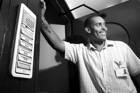 A worker stands beside Woodside