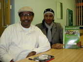 Ahmed and Yasmin with a copy of the report .