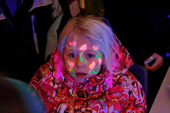A child painted with orange flowers
