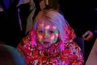 A child painted with orange flowers