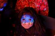 A child with a moonlit forest painted on her face