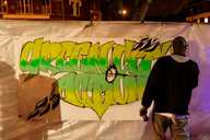 Artist Shaun Tummings creating a mural