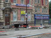 Flood damage to safety barriers and building materials.