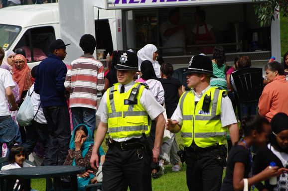 Policeman walking and talking.