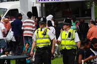 Policeman walking and talking.
