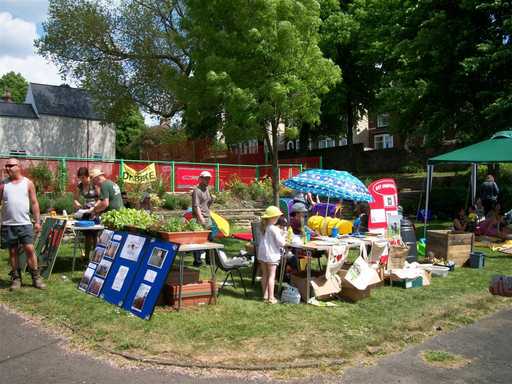Stalls and people on grass in Abbeyfield Park