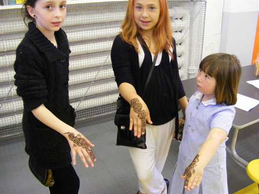 Girls show off their henna tattoos