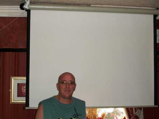 Kevin Greaves of the Royal Oak, in front of his big screen.