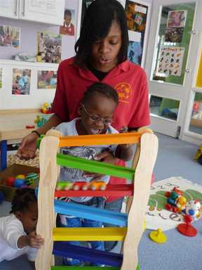 Children playing with nursery worker