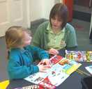 Child and adult reading together