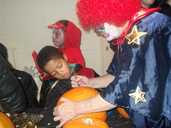 Clown carves the pumkin