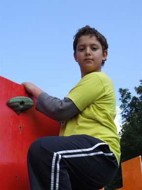 Lad at top of cimbing wall