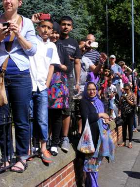 Young photographers stood on a wall